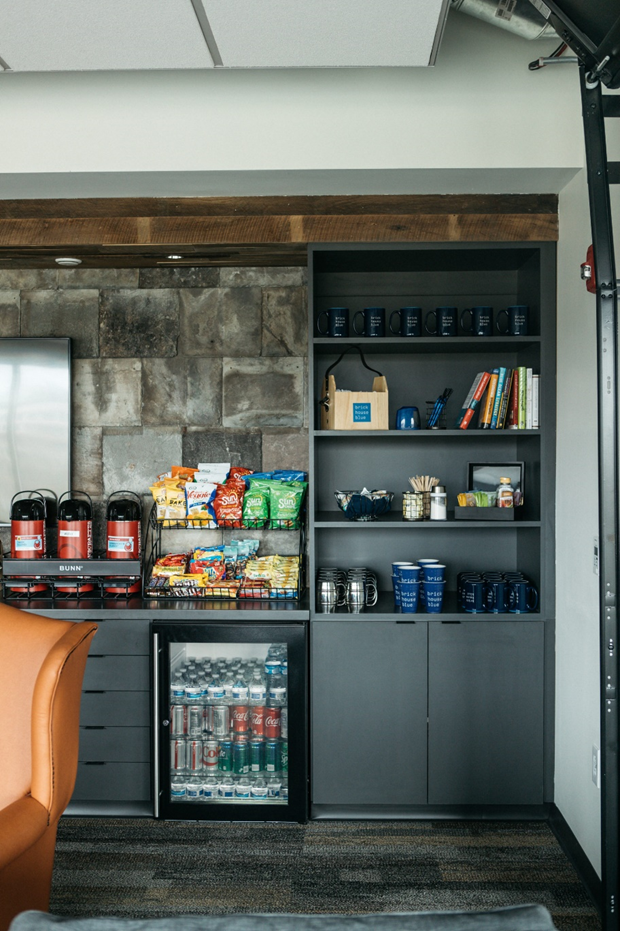 A amenity station offering snacks, beverages, and gourmet coffee at brick house blue's headquarters in dublin, ohio