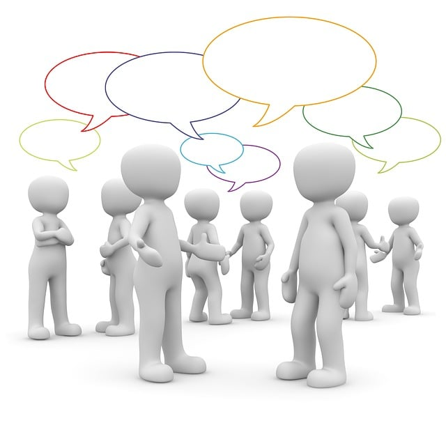 This is a 3d illustration of featureless human figures in various poses engaging in conversation, as indicated by the colorful speech bubbles above their heads. The figures are arranged in pairs and small groups, suggesting active communication and social interaction, much like what happens in networking events or collaborative meeting spaces.
